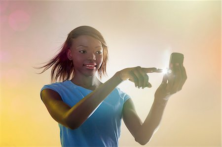 digital communication - Teenage girl using illuminated cellphone Stock Photo - Premium Royalty-Free, Code: 614-06169331