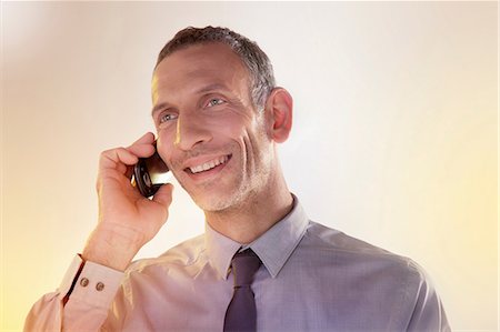 Businessman using cellphone Stock Photo - Premium Royalty-Free, Code: 614-06169343