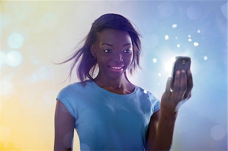 Teenage girl using illuminated cellphone Stock Photo - Premium Royalty-Free, Code: 614-06169351