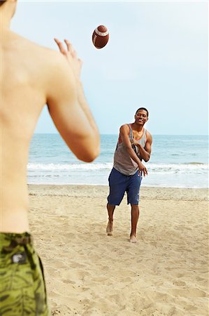 playing rugby - Two young men playing rugby on beach Stock Photo - Premium Royalty-Free, Code: 614-06169391
