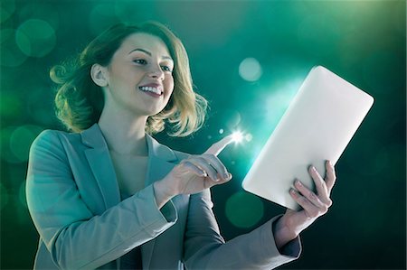 people tablet digital light - Young woman digital tablet and light on finger Stock Photo - Premium Royalty-Free, Code: 614-06169428