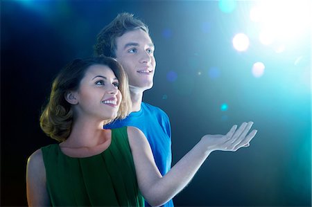 digitally generated image - Young couple looking up at light Stock Photo - Premium Royalty-Free, Code: 614-06169439