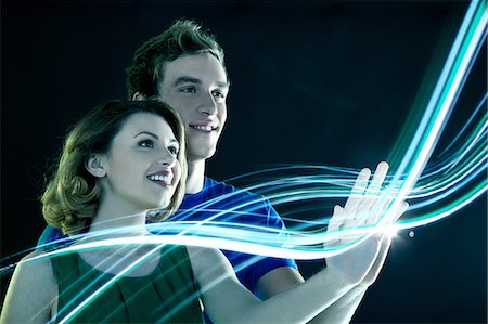 fibra óptica - Young couple touching streams of light Foto de stock - Sin royalties Premium, Código: 614-06169448
