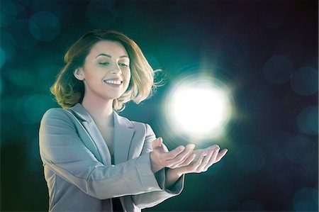 potencia - Young woman holding ball of light Foto de stock - Sin royalties Premium, Código: 614-06169440