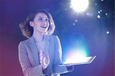 future of light - Young woman looking at lights coming from digital tablet Stock Photo - Premium Royalty-Free, Code: 614-06169443