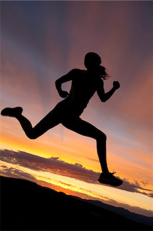 runners silhouette - Silhouette of athlete jumping against sunset Stock Photo - Premium Royalty-Free, Code: 614-06169450