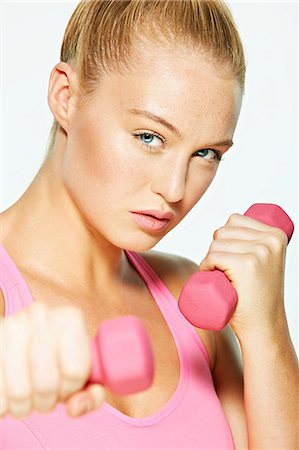 strong human physical strength - Young woman using hand weights Stock Photo - Premium Royalty-Free, Code: 614-06169475