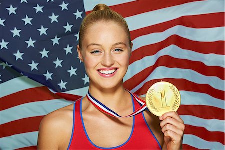 sport woman winner - Young woman in front of USA flag with gold medal Stock Photo - Premium Royalty-Free, Code: 614-06169501