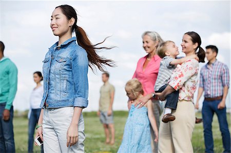 diverse community - Young woman and group of people outdoors Stock Photo - Premium Royalty-Free, Code: 614-06169527