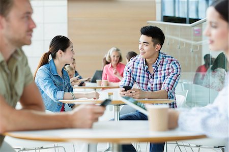 female sitting waiting room - Young couple in canteen area Stock Photo - Premium Royalty-Free, Code: 614-06169545