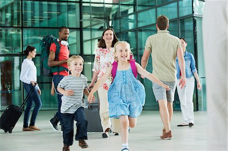 family and vacation and airport - Excited children running on airport concourse Stock Photo - Premium Royalty-Free, Code: 614-06311624