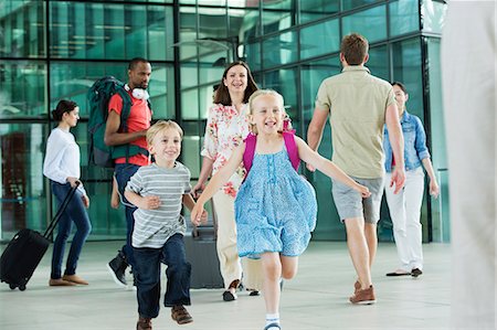 family traveling not caucasian - Excited children running on airport concourse Stock Photo - Premium Royalty-Free, Code: 614-06311624