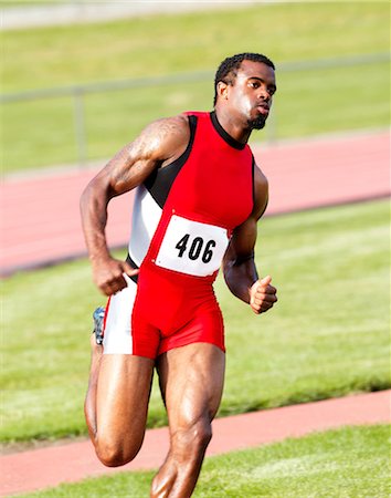 sprinter concentration - Male athlete running on track Stock Photo - Premium Royalty-Free, Code: 614-06311637