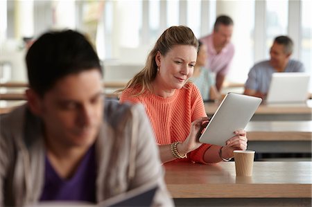 education - Woman using digital tablet in class Stock Photo - Premium Royalty-Free, Code: 614-06311669