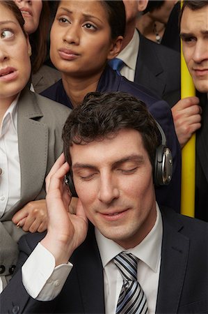 people commuting on trains - Businesswoman wearing headphones on subway train Stock Photo - Premium Royalty-Free, Code: 614-06311758