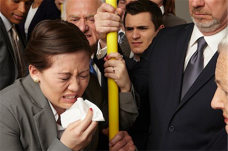 Businesswoman sneezing on subway train Stock Photo - Premium Royalty-Free, Code: 614-06311769
