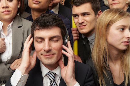 people commuting on trains - Businesswoman wearing headphones on subway train Stock Photo - Premium Royalty-Free, Code: 614-06311794