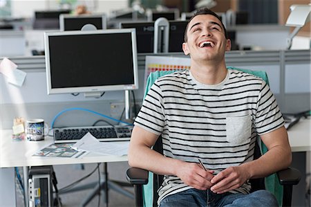 Man laughing in office Stock Photo - Premium Royalty-Free, Code: 614-06311906