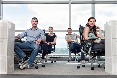 Creative business people sitting at workstations Stock Photo - Premium Royalty-Free, Code: 614-06311911