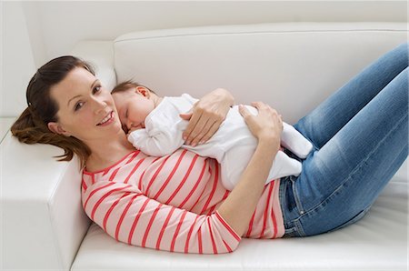 Woman and baby girl resting on sofa Stock Photo - Premium Royalty-Free, Code: 614-06312004