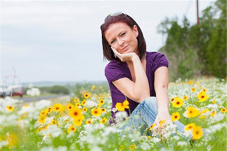 female tshirt - Mid adult woman sitting in a field of flowers Stock Photo - Premium Royalty-Free, Code: 614-06336184