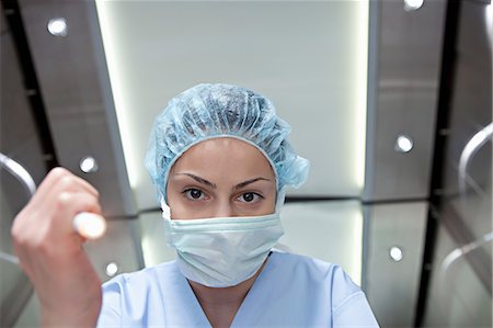 female surgeon in operation - Surgeon shining torch, personal perspective Stock Photo - Premium Royalty-Free, Code: 614-06336234