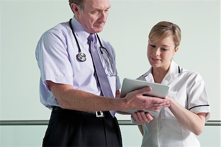 simsearch:614-06336248,k - Doctor and nurse discussing medical records on digital tablet Stock Photo - Premium Royalty-Free, Code: 614-06336245