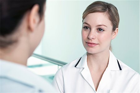 Nurse listening to colleague Stock Photo - Premium Royalty-Free, Code: 614-06336252