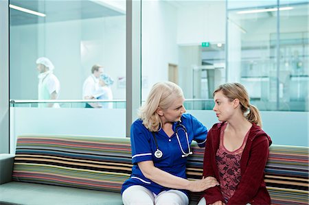 Nurse talking to woman in hospital waiting room Stock Photo - Premium Royalty-Free, Code: 614-06336269