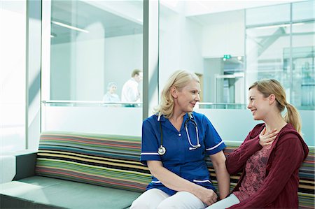 Nurse talking to woman in hospital waiting room Stock Photo - Premium Royalty-Free, Code: 614-06336270