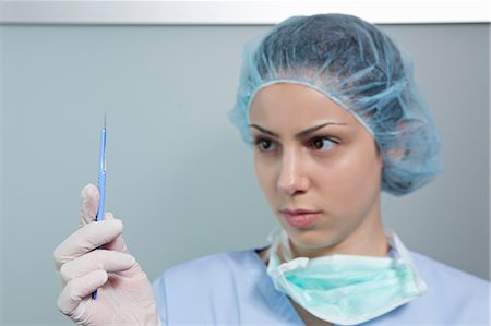 surgeon gloves blue - Surgeon holding scalpel Stock Photo - Premium Royalty-Free, Code: 614-06336272