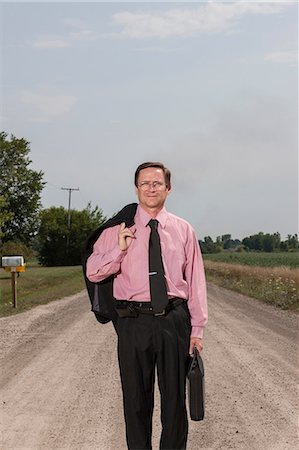 Businessman on country road Stock Photo - Premium Royalty-Free, Code: 614-06336458