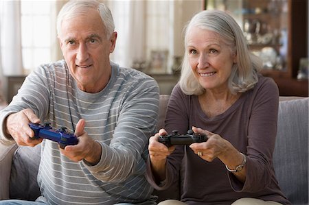 Senior couple playing video game Stock Photo - Premium Royalty-Free, Code: 614-06336451