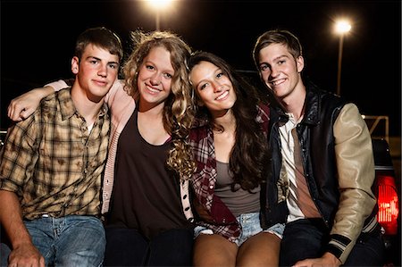 sitting on the tailgate - Portrait of four friends with arms around each other Stock Photo - Premium Royalty-Free, Code: 614-06402552