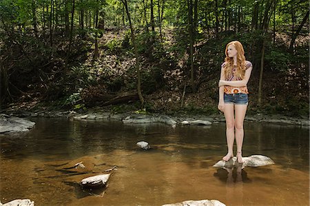 red hair - Teenage girl standing on rock in river Stock Photo - Premium Royalty-Free, Code: 614-06402623