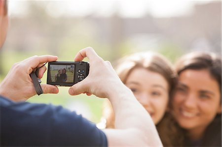 digitalkamera - Homme qui prend une photo de deux jeunes femmes Photographie de stock - Premium Libres de Droits, Code: 614-06402743