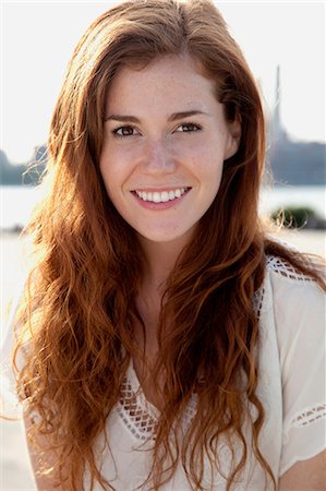 Young woman with long red hair, portrait Stock Photo - Premium Royalty-Free, Code: 614-06402820