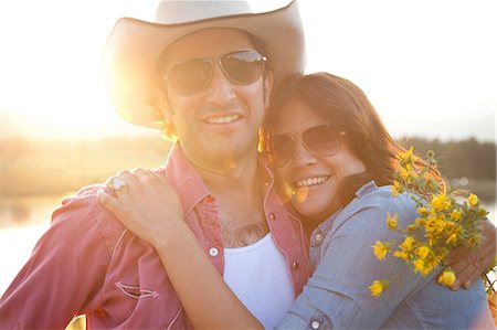 evening sunlight - Happy couple in sunlight with flowers Stock Photo - Premium Royalty-Free, Code: 614-06402862