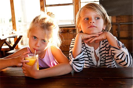 picnic table photography - Girl drinking juice and boy looking thoughtful Stock Photo - Premium Royalty-Free, Code: 614-06402893