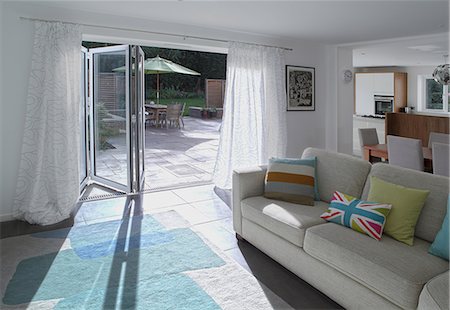 Open plan living area with open patio doors Stock Photo - Premium Royalty-Free, Code: 614-06402965