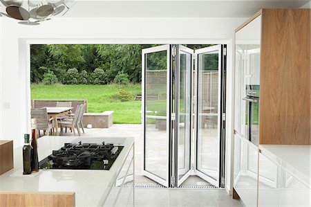 Kitchen with open patio doors Stock Photo - Premium Royalty-Free, Code: 614-06402979