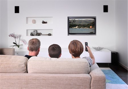 rear view of a boy - Family on sofa watching television, rear view Stock Photo - Premium Royalty-Free, Code: 614-06403006