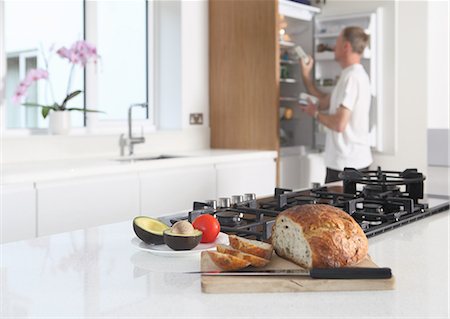 preparing and sandwich - Man in kitchen, preparing food Stock Photo - Premium Royalty-Free, Code: 614-06403000