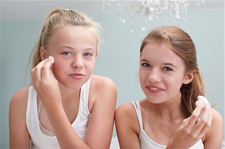 Teenage girls cleansing their faces Stock Photo - Premium Royalty-Free, Code: 614-06403065