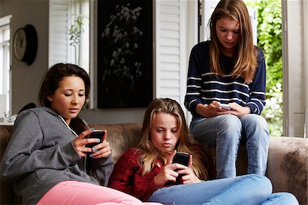 people looking at smartphone home not children - Teenage girls using cellphones Stock Photo - Premium Royalty-Free, Code: 614-06403069