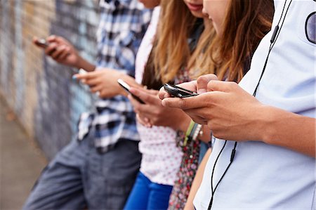 Teenagers using cellphones Stock Photo - Premium Royalty-Free, Code: 614-06403078