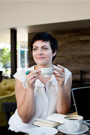 Young woman in cafe with tea Stock Photo - Premium Royalty-Free, Code: 614-06403104