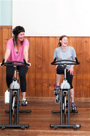 simsearch:614-06403132,k - Two women on exercise bikes Stock Photo - Premium Royalty-Free, Code: 614-06403129