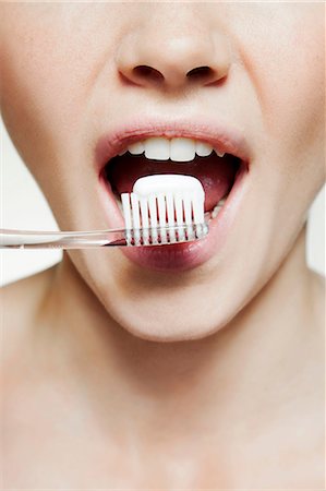 Woman brushing teeth Stock Photo - Premium Royalty-Free, Code: 614-06442345