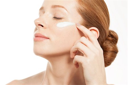 simsearch:614-06442320,k - Woman applying moisturiser with eyes closed Stock Photo - Premium Royalty-Free, Code: 614-06442375